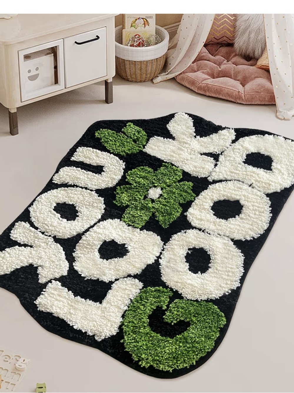 Black Fuzzy Rug with Cream Letters and Green Floral Accents